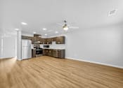 Thumbnail 3 of 26 - A kitchen with wooden floors and white walls.at Hawthorne Pointe, Bondurant  