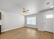 Thumbnail 1 of 26 - A room with a ceiling fan and wooden flooring.at Hawthorne Pointe, Iowa  