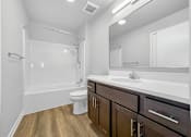 Thumbnail 10 of 26 - A white bathroom with wooden floors and a white toilet.at Hawthorne Pointe, Bondurant, IA 50035  