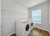 Thumbnail 9 of 26 - A laundry room with a washer and dryer.at Hawthorne Pointe, Bondurant Iowa  