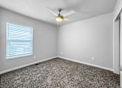 Thumbnail 12 of 26 - A room with a ceiling fan and carpeted floor.at Hawthorne Pointe, Bondurant Iowa  