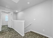 Thumbnail 7 of 26 - A room with a carpeted floor and a staircase leading to another room.at Hawthorne Pointe, Iowa, 50035
