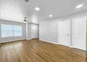 Thumbnail 2 of 26 - A room with wooden floors and white walls.at Hawthorne Pointe, Iowa, 50035