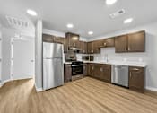 Thumbnail 5 of 26 - A kitchen with wooden floors and stainless steel appliances.at Hawthorne Pointe, Bondurant, IA  