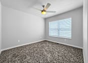Thumbnail 13 of 26 - A room with a ceiling fan and a window with blinds.at Hawthorne Pointe, Bondurant, 50035  