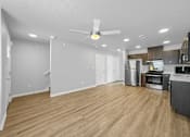 Thumbnail 8 of 26 - A spacious kitchen and living room with wood flooring and modern appliances.at Hawthorne Pointe, Bondurant, 50035  