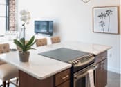 Thumbnail 19 of 39 - Kitchen with a white counter top and brown cabinets at Clemens Building, Des Moines, IA, 50309