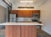 Thumbnail 8 of 39 - Kitchen with wooden cabinets and a white countertop at Clemens Building, Iowa