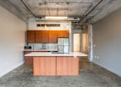 Thumbnail 34 of 39 - Kitchen with wood cabinets and stainless steel appliances at Clemens Building, Des Moines, IA, Iowa , 50309