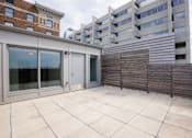Thumbnail 32 of 39 - Patio with a sliding glass door and a wooden fence at Clemens Building, Des Moines