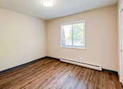 Thumbnail 13 of 19 - A room with a window and a white door at The Hampton Meadows Apartments,Des Moines, Iowa