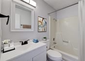 Thumbnail 4 of 19 - A white bathroom with a white toilet, sink, and bathtub at The Hampton Meadows Apartments,Des Moines, Iowa