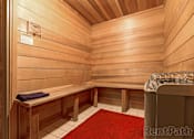 Thumbnail 14 of 19 - A wooden sauna with a red carpet and benches at The Hampton Meadows Apartments, Iowa