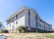 Thumbnail 5 of 21 - A modern building with a flat roof and a stone base at The Ridges Apartments, Des Moines, IA,  50315