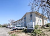 Thumbnail 9 of 21 - residential building with a parking lot in front at The Ridges Apartments, Des Moines, IA