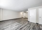 Thumbnail 14 of 21 - A room with a wooden floor and white walls at The Ridges Apartments, Iowa, 50315