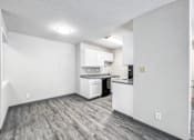Thumbnail 15 of 21 - A kitchen area with white cabinets and a dishwasher at The Ridges Apartments, Des Moines, IA,  50315