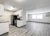 Thumbnail 16 of 21 - A kitchen with white cabinets and a black refrigerator at The Ridges Apartments, Des Moines, Iowa