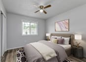 Thumbnail 4 of 18 - A bedroom with a bed, pillows, a ceiling fan, and a window.at Fish Creek, Norwalk, IA  