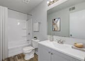 Thumbnail 5 of 18 - A white bathroom with a toilet, sink, and shower.at Fish Creek, Norwalk, IA  