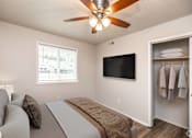 Thumbnail 6 of 18 - A bedroom with a bed, a television, and a window.at Fish Creek, Norwalk Iowa  