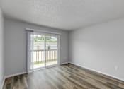 Thumbnail 7 of 18 - A room with a sliding glass door leading to a balcony.at Fish Creek, Iowa  