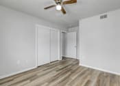 Thumbnail 8 of 18 - A room with a ceiling fan and wooden flooring.at Fish Creek, Iowa, 50211