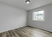 Thumbnail 17 of 18 - A room with a window and wooden flooring.at Fish Creek, Iowa  