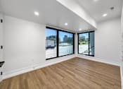 Thumbnail 14 of 30 - an empty living room with large windows and wood floors  at Matilda 235 Townhomes, Des Moines, 50309