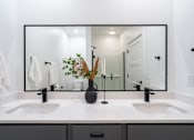 Thumbnail 12 of 30 - a bathroom with two sinks and a large mirror at Matilda 235 Townhomes, Des Moines, IA