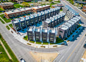 Thumbnail 28 of 30 - an aerial view of an apartment building with cars driving around it at Matilda 235 Townhomes, Des Moines, IA