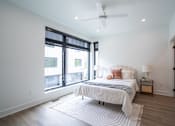 Thumbnail 10 of 30 - a bedroom with a bed and a large window at Matilda 235 Townhomes, Des Moines
