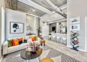 Thumbnail 1 of 53 - A modern living room with a grey couch, a coffee table, and a bookshelf.at Level, Iowa, 50309