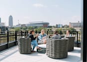 Thumbnail 5 of 53 - A group of people are sitting on a rooftop terrace.at Level, Des Moines  