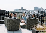 Thumbnail 8 of 53 - Four people sitting on a rooftop terrace.at Level, Iowa   