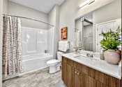 Thumbnail 22 of 53 - A bathroom with a toilet, sink, and shower.at Level, Des Moines, IA 50309  