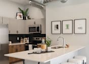 Thumbnail 23 of 53 - A kitchen with a white counter and stools.at Level, Iowa, 50309