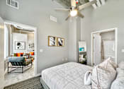 Thumbnail 24 of 53 - A bedroom with a bed, a chair, and a ceiling fan.at Level, Des Moines, IA  