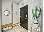 Thumbnail 29 of 53 - A black door is in a white room with a plant on a side table.at Level, Iowa, 50309