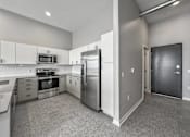 Thumbnail 30 of 53 - A kitchen with a refrigerator, oven, and microwave.at Level, Des Moines Iowa   