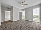 Thumbnail 38 of 53 - A room with a ceiling fan and carpeted floor.at Level, Des Moines, IA 50309  