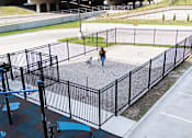 Thumbnail 43 of 53 - A woman walking a dog in a fenced area.at Level, Des Moines  