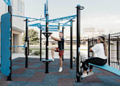 Thumbnail 47 of 53 - A man and a woman are exercising at a park.at Level, Des Moines  