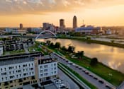 Thumbnail 51 of 53 - A cityscape with a river and a bridge during sunset.at Level, Des Moines, IA  