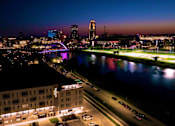 Thumbnail 44 of 53 - A cityscape at night with a river running through it.at Level, Des Moines, 50309  