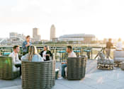 Thumbnail 18 of 53 - A group of people are sitting on a rooftop terrace.at Level, Iowa   