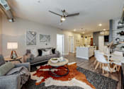 Thumbnail 15 of 34 - an open living room and kitchen with a ceiling fan at Linc, Iowa   