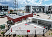 Thumbnail 34 of 34 - an aerial view of a building with a parking lot and other buildings at Linc, Des Moines, IA 50309  