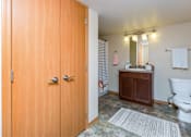 Thumbnail 10 of 35 - a bathroom with a wooden door and a toilet and a sink at Melbourne Apartments, Georgia
