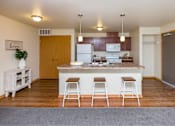 Thumbnail 1 of 35 - a kitchen with a large island with three bar stools at Melbourne Apartments, Iowa, 50320